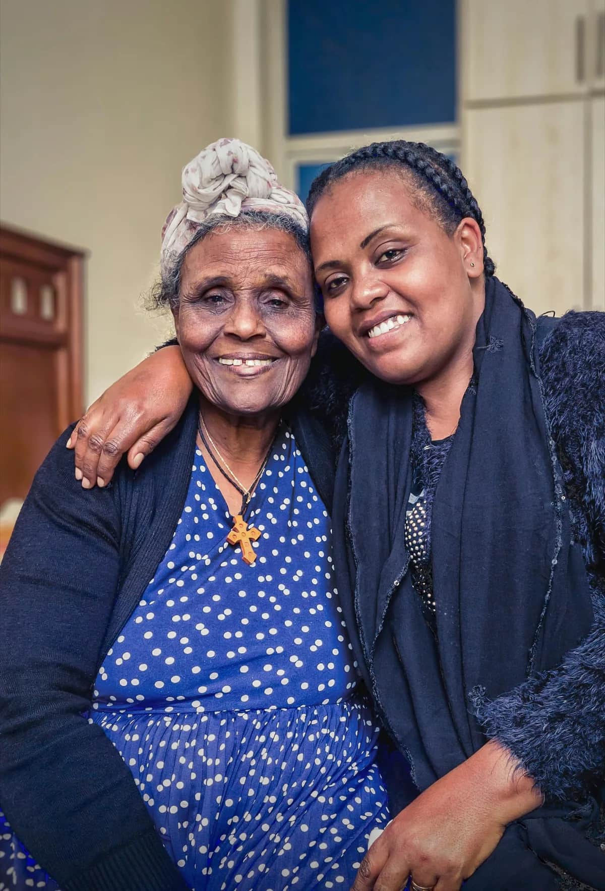 An Indiana family caregiver sitting with an elderly loved one at home, representing paid family caregiving through the Structured Family Caregiving program